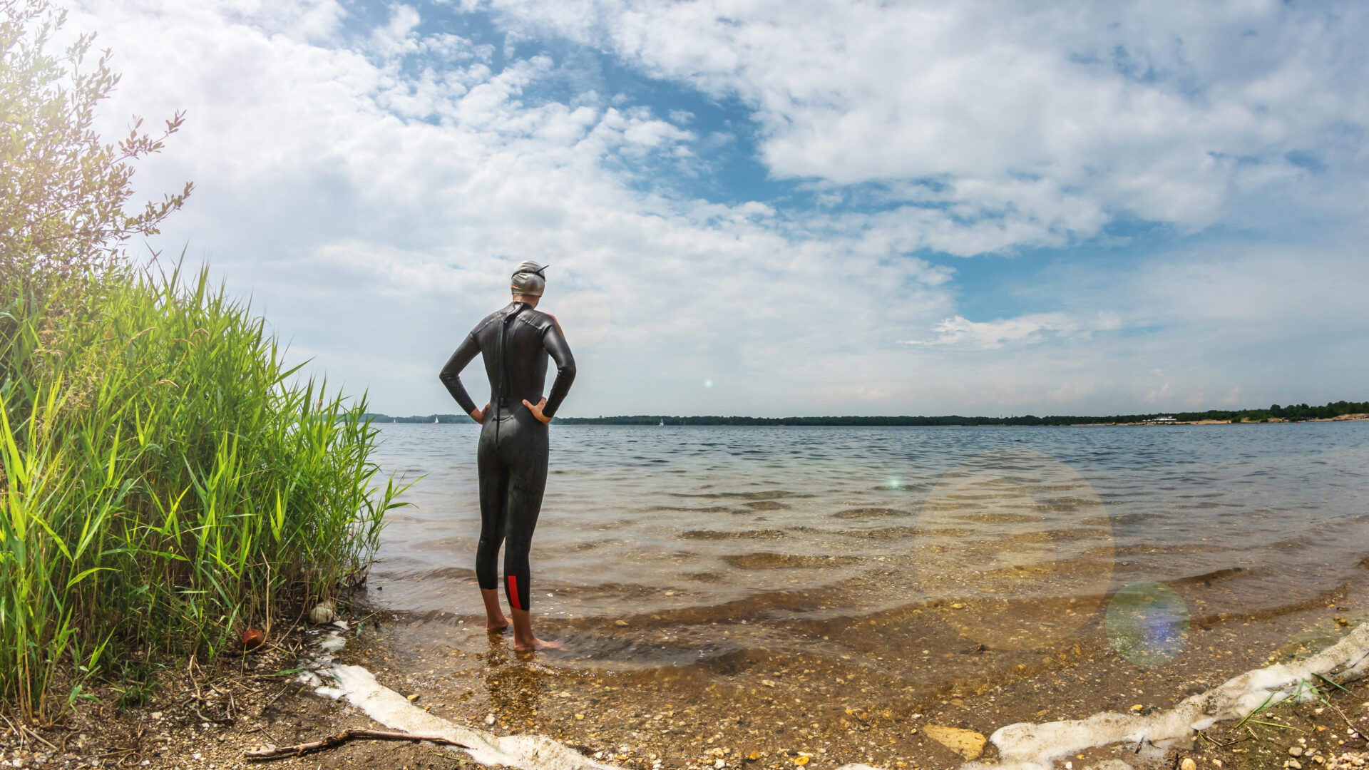 Triathlete,Standing,In,A,Lake,Before,Swim