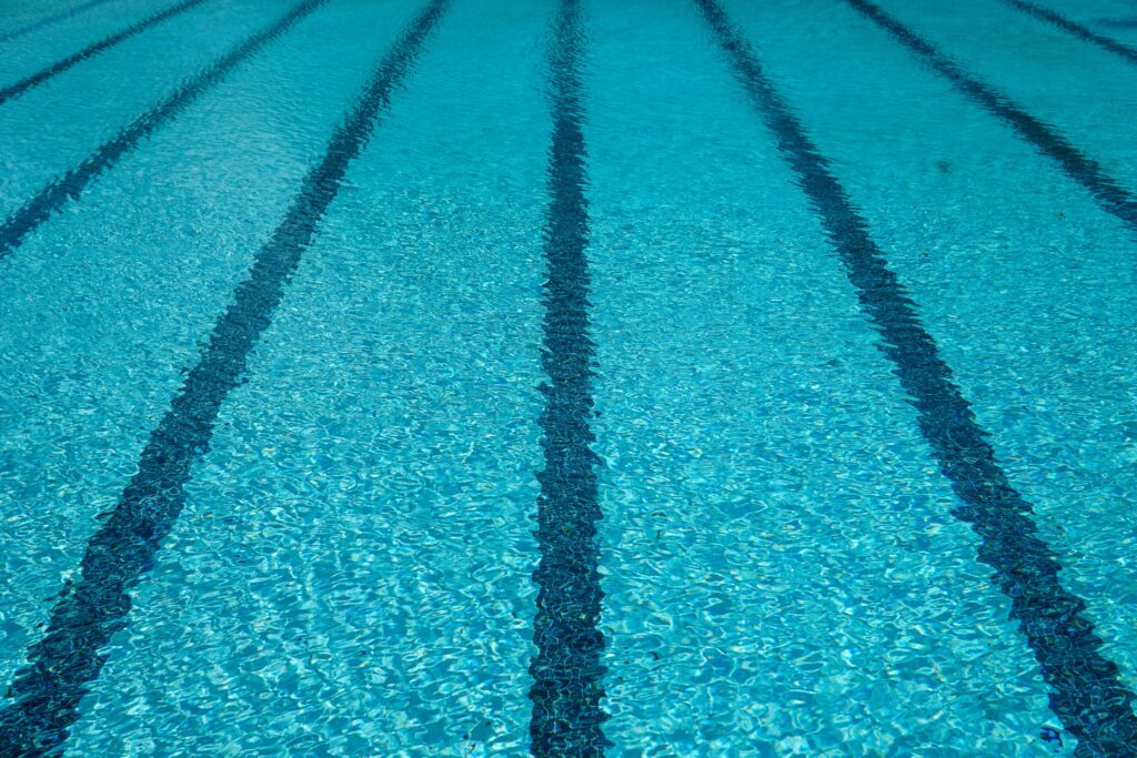 Picture of a crystal-clear pool in Greenville, SC, with lanes clearly delineated under the water on the pool floor, creating an inviting environment for swimmers and training sessions.